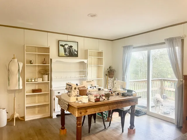 a dining room with furniture and wooden floor