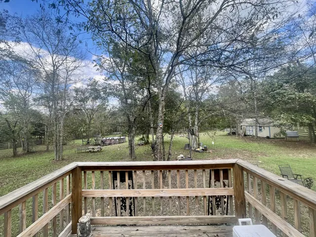 a view of a barn in the middle of a yard