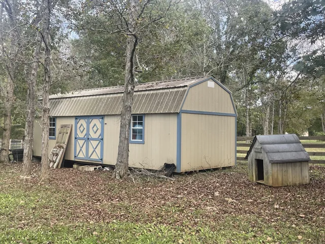 a view of a yard with wooden fence