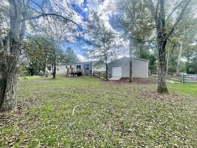 a view of a field with a tree in it