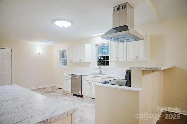 a kitchen with white cabinets and appliances