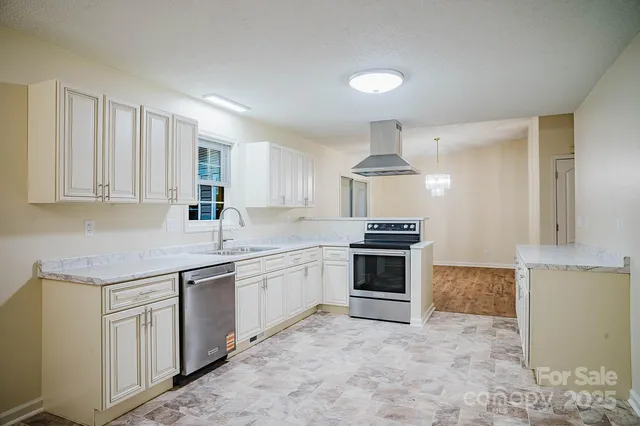 a kitchen with stainless steel appliances granite countertop a stove and a sink