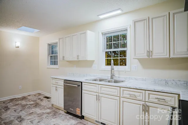 a kitchen with a sink cabinets and window