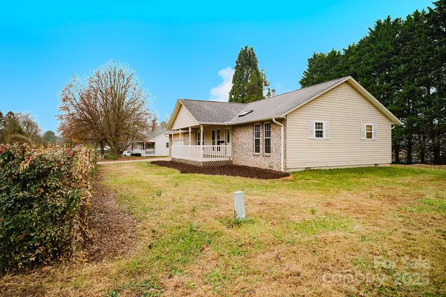 a view of a house with pool and sitting area
