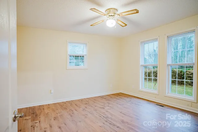 a view of wooden floor and windows in a room