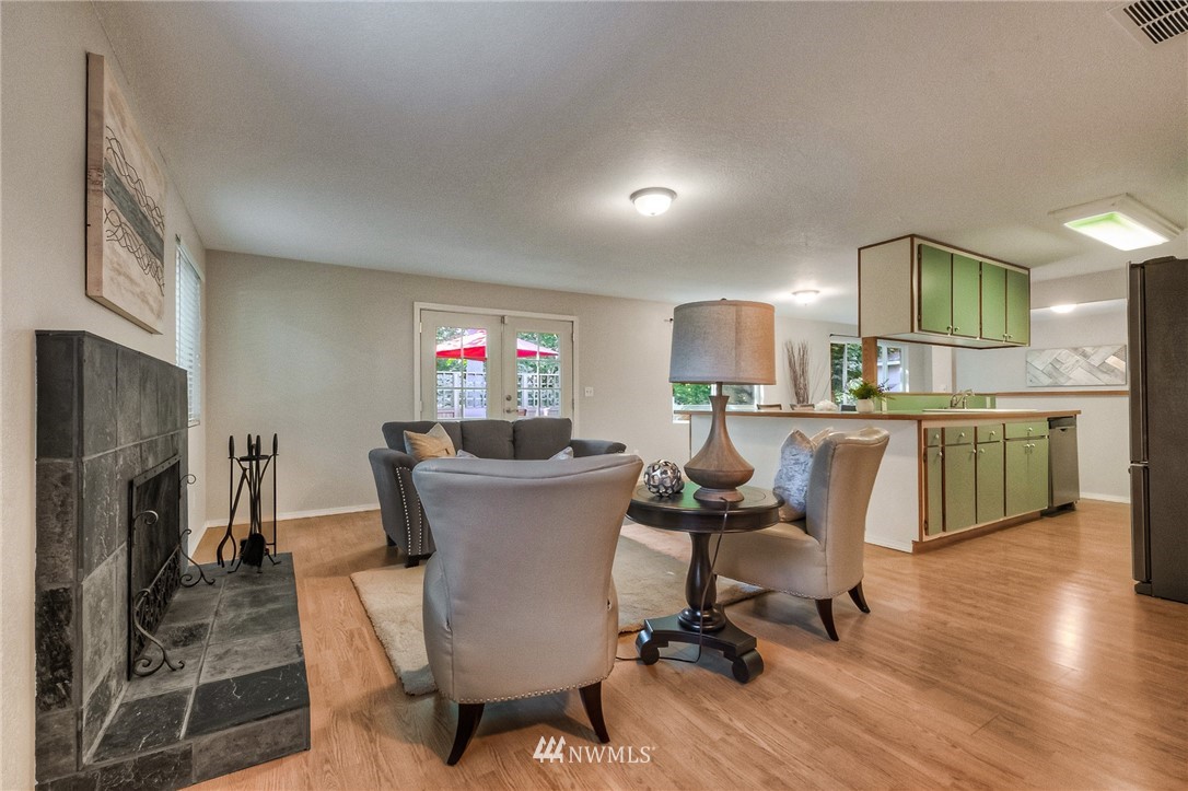 13708 Southeast 141st Street Renton, WA 98059 - Photo 12 of 19 a view of a dining room with furniture and a fireplace