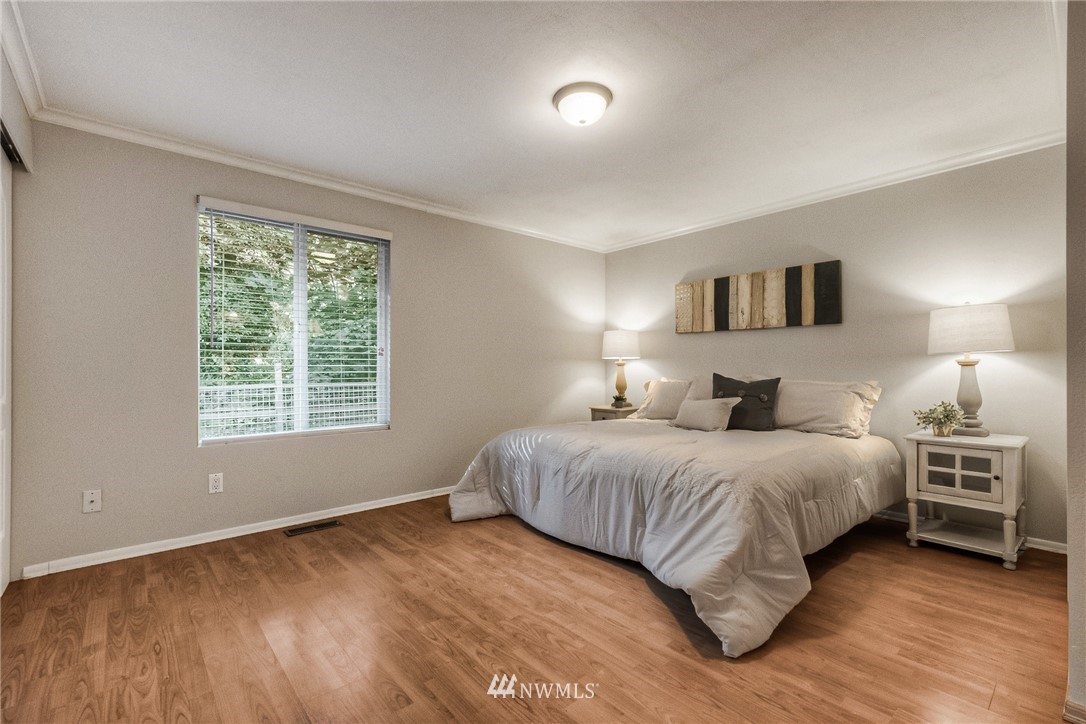 13708 Southeast 141st Street Renton, WA 98059 - Photo 15 of 19 a bedroom with a bed and a night stand