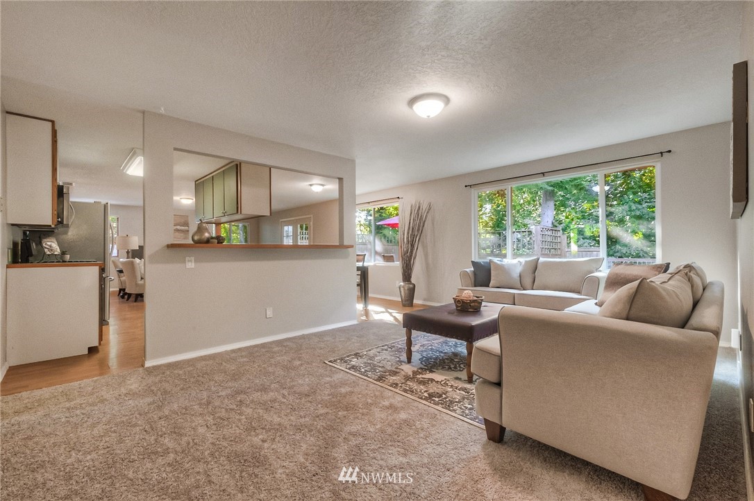 13708 Southeast 141st Street Renton, WA 98059 - Photo 5 of 19 a living room with furniture and a large window