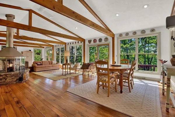 a dining room with furniture window and wooden floor