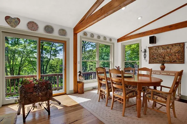 a dining room with furniture window and wooden floor