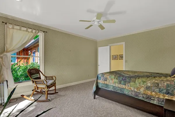 a bedroom with a bed and a window