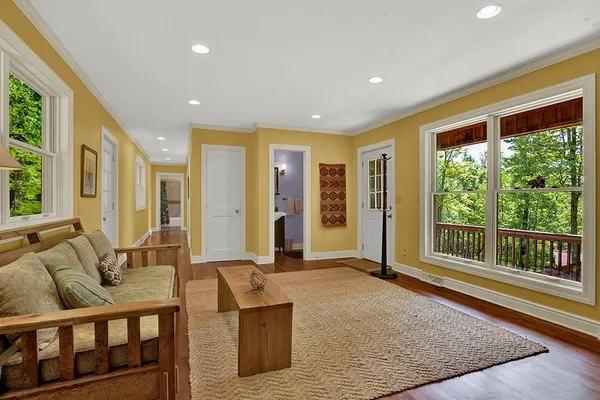 a living room with furniture and large windows