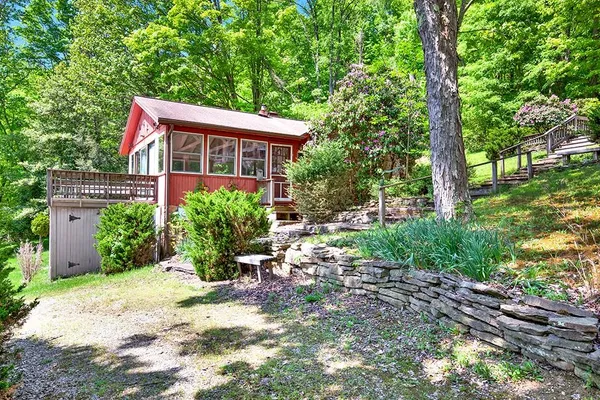 a view of a house with backyard sitting area and garden