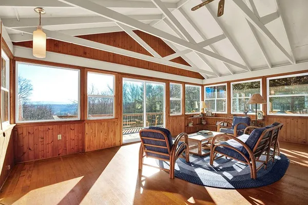 a living room with furniture and floor to ceiling windows