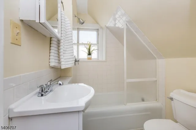 a bathroom with a sink a toilet and a bathtub