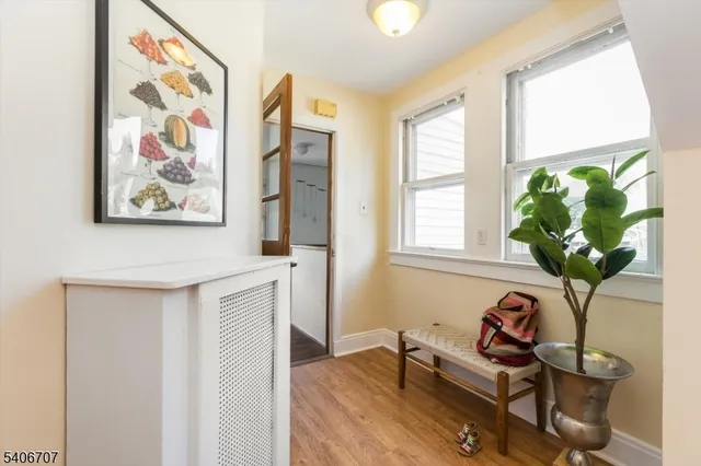 a view of a workspace with furniture and a potted plant