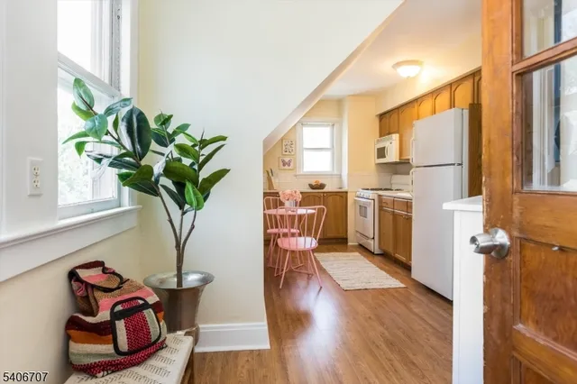 a hallway with a dining table and a potted plant