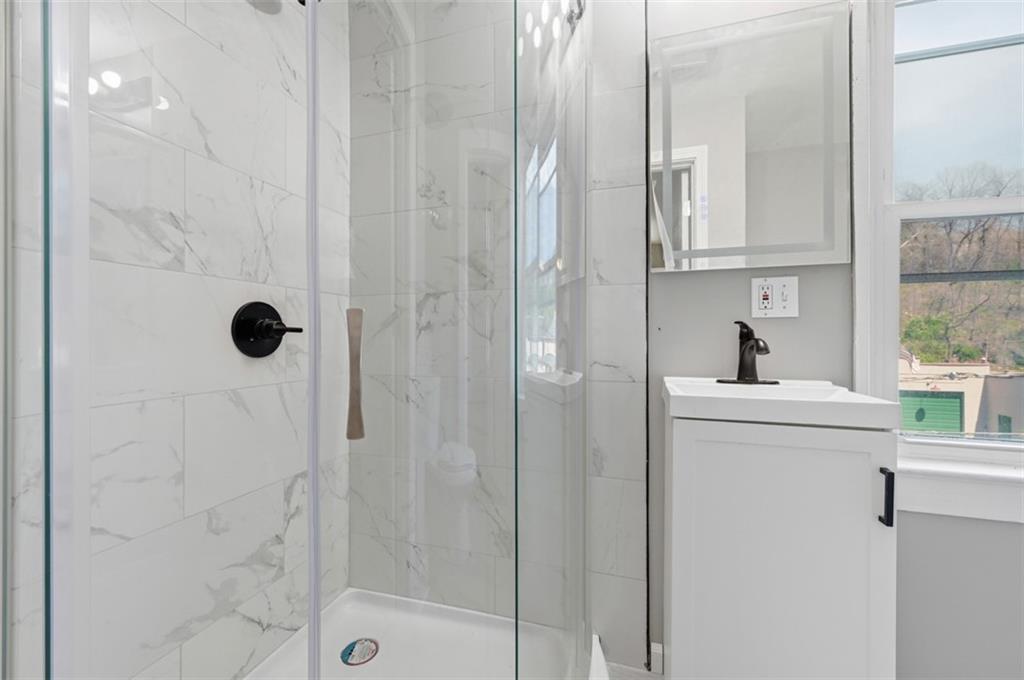1014 McLaughlin Run Road Bridgeville, PA 15017 - Photo 21 of 25 a bathroom with a shower a sink and mirror