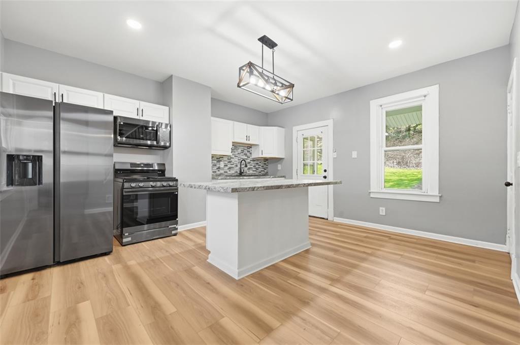 1014 McLaughlin Run Road Bridgeville, PA 15017 - Photo 3 of 25 a kitchen with stainless steel appliances granite countertop a refrigerator and a sink