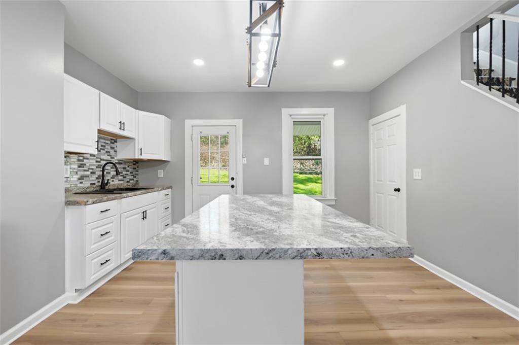 1014 McLaughlin Run Road Bridgeville, PA 15017 - Photo 5 of 25 a kitchen with granite countertop a stove a sink and a refrigerator