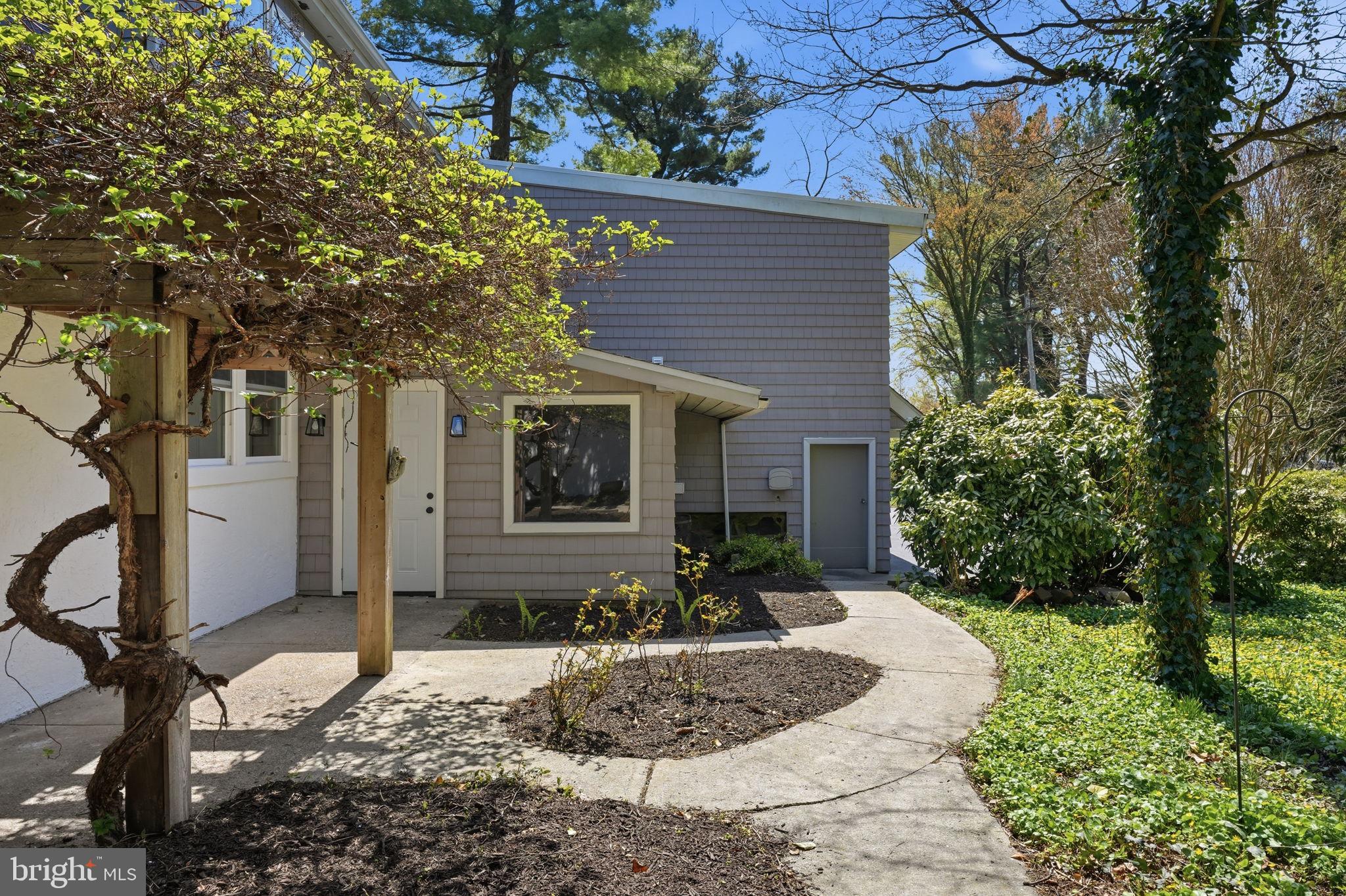 409 South Providence Road Wallingford, PA 19086 - Photo 11 of 106 Charming home with lush greenery.