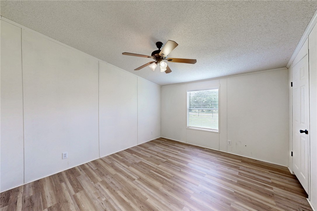 11459 Winstead Lane Calvert, TX 77837 - Photo 16 of 37 a view of empty room with wooden floor and fan