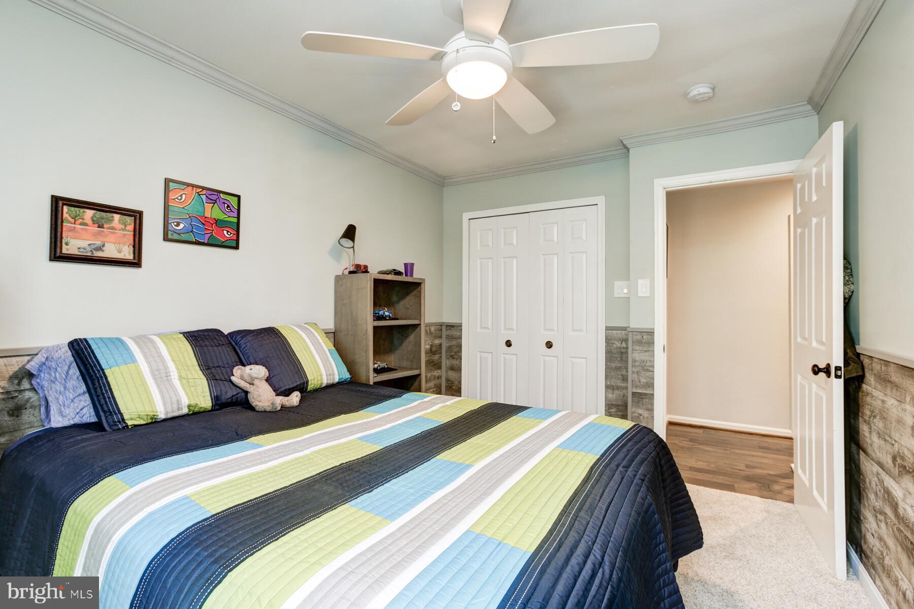 307 Saddle Ridge Road Annapolis, MD 21403 - Photo 31 of 46 a bedroom with a bed and a chandelier