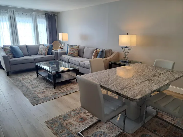 a living room with furniture and a lamp