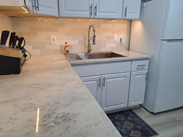 a white toilet sitting next to a bathroom sink