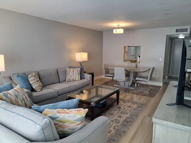 a view of a house with a yard and flower plants