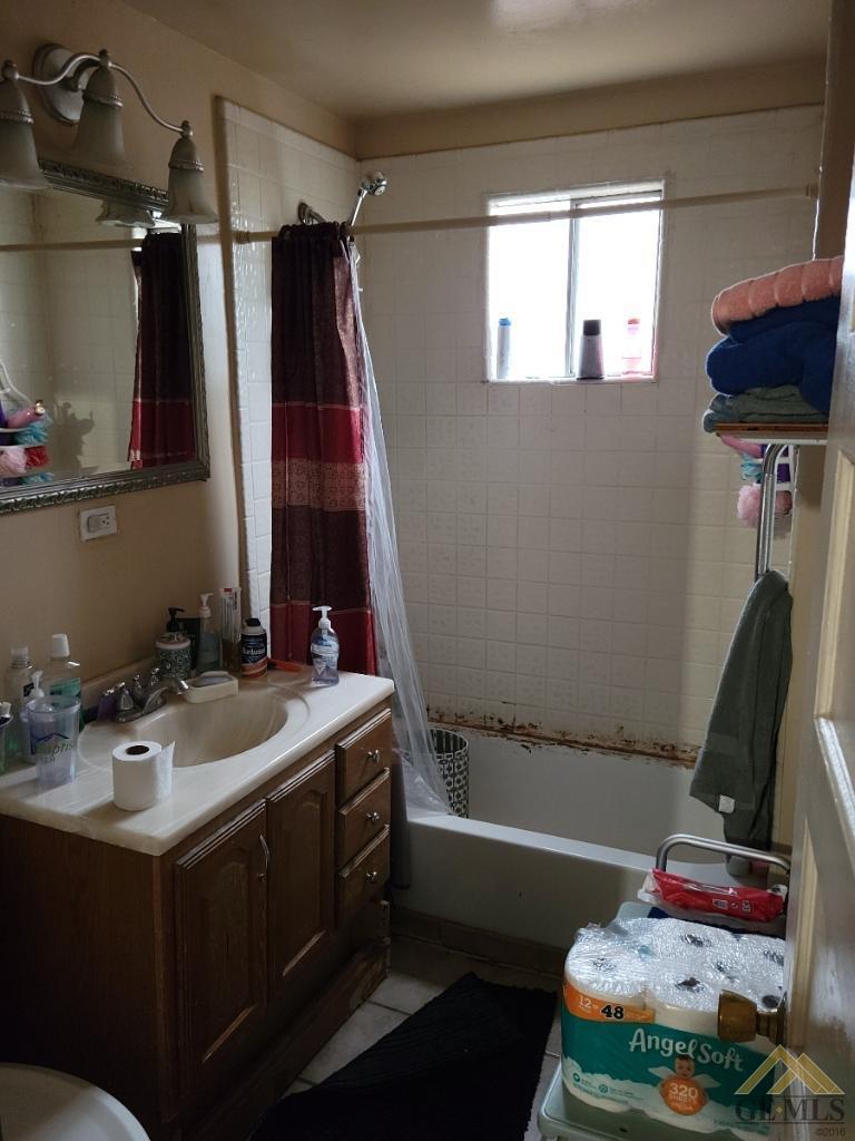 Undisclosed Address Bakersfield, CA 93305 - Photo 12 of 13 a bathroom with a sink and a mirror