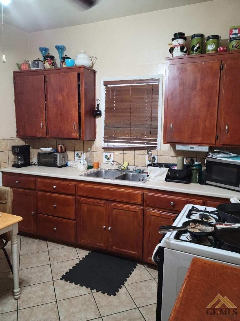 Undisclosed Address Bakersfield, CA 93305 - Photo 7 of 13 a kitchen with stainless steel appliances granite countertop a sink stove and cabinets
