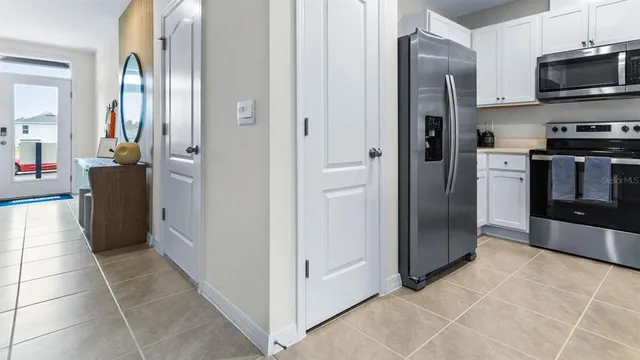 a kitchen with stainless steel appliances a stove refrigerator sink and cabinets