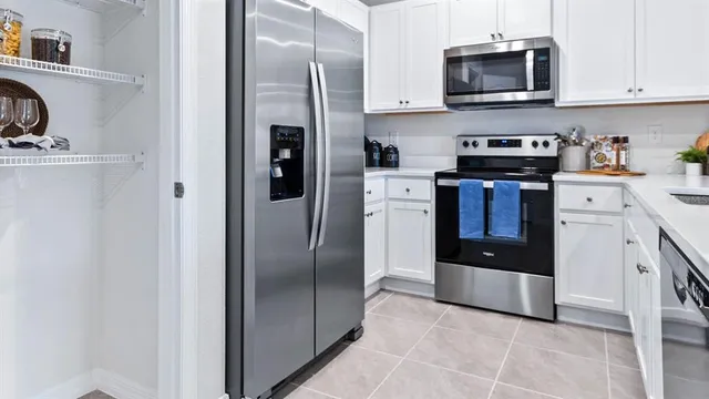 a kitchen with a sink and refrigerator