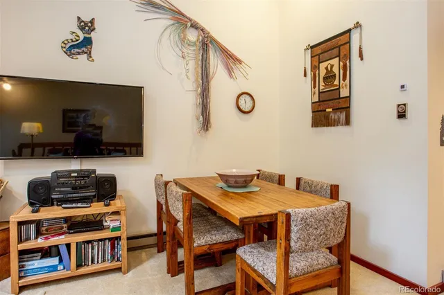 a dining room with furniture and a flat screen tv