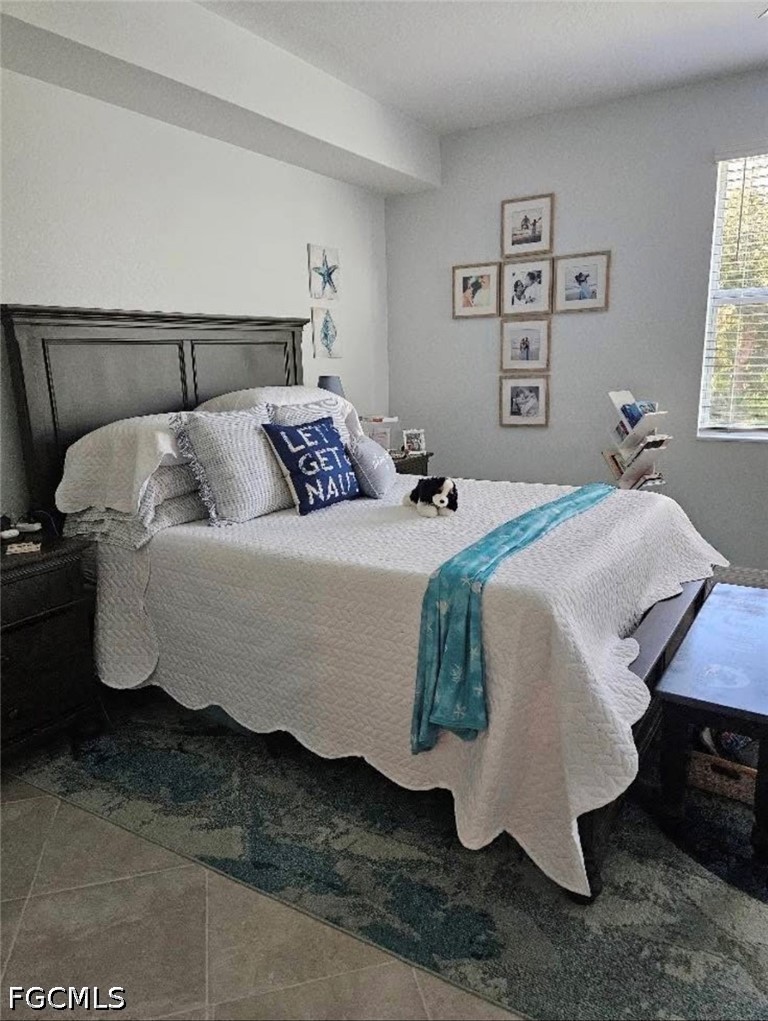 14191 Poppy Fld Loop, Unit 5312 Punta Gorda, FL 33955 - Photo 18 of 41 a bedroom with a bed and wooden floor