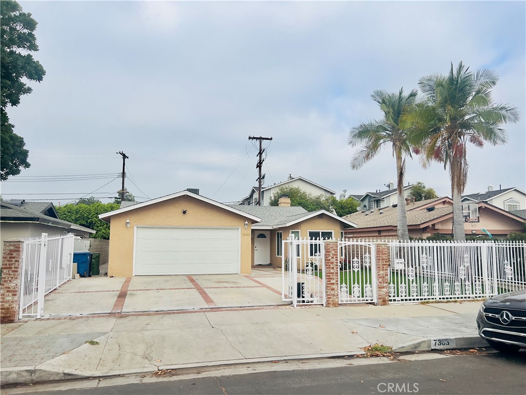 7363 Bothwell Road Reseda, CA 91335 - Photo 1 of 28 a front view of a house with a yard and garage