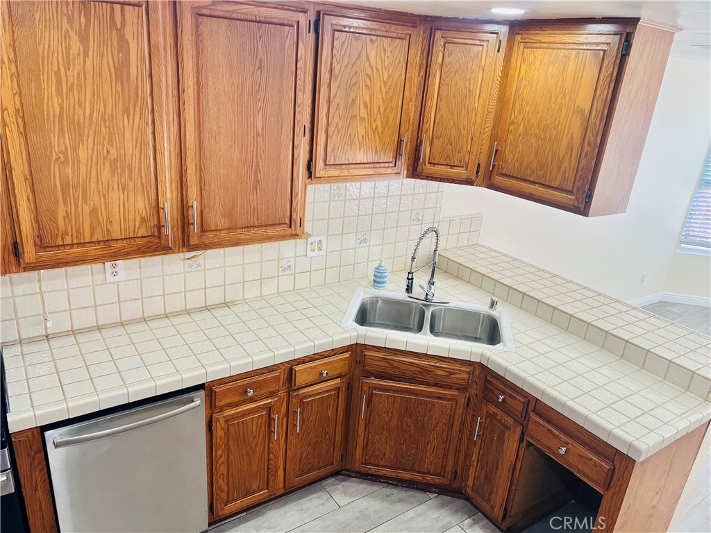 7363 Bothwell Road Reseda, CA 91335 - Photo 13 of 28 a kitchen with stainless steel appliances granite countertop white cabinets a sink and dishwasher