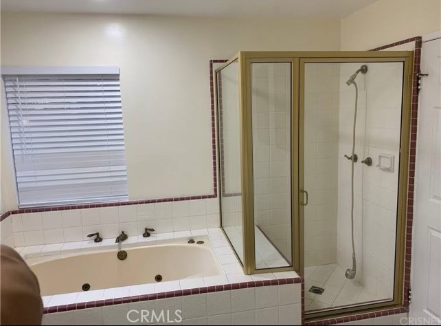 7363 Bothwell Road Reseda, CA 91335 - Photo 14 of 28 a bathroom with a tub and a shower