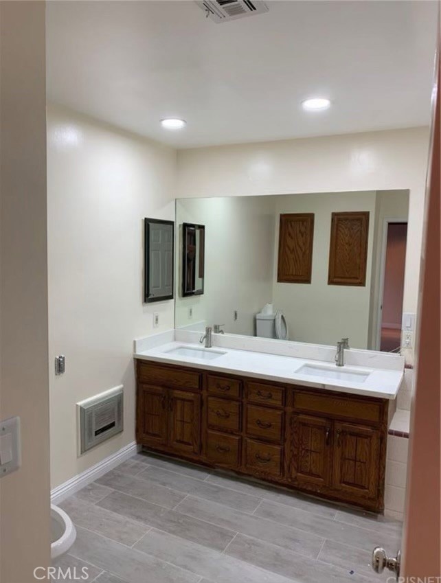 7363 Bothwell Road Reseda, CA 91335 - Photo 15 of 28 a spacious bathroom with a double vanity sink and mirror