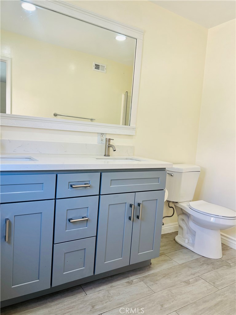 7363 Bothwell Road Reseda, CA 91335 - Photo 18 of 28 a bathroom with a toilet a sink and a mirror