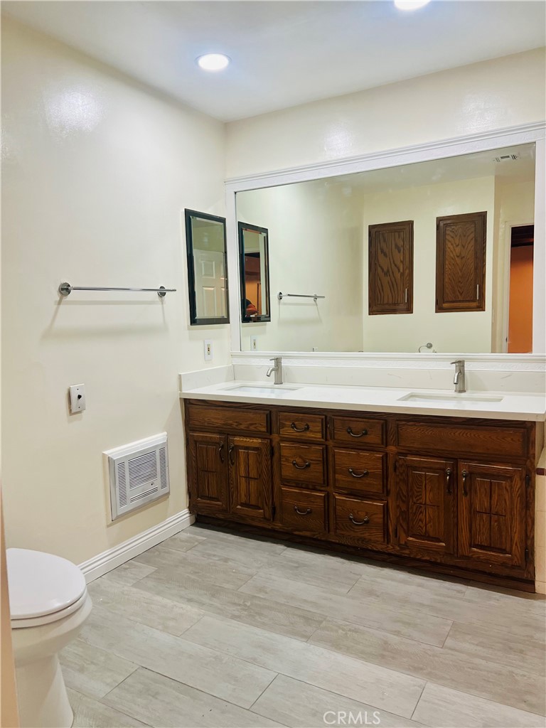 7363 Bothwell Road Reseda, CA 91335 - Photo 22 of 28 a spacious bathroom with a double vanity sink a large mirror and toilet