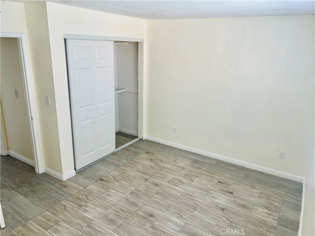 7363 Bothwell Road Reseda, CA 91335 - Photo 26 of 28 an empty room with wooden floor and entrance