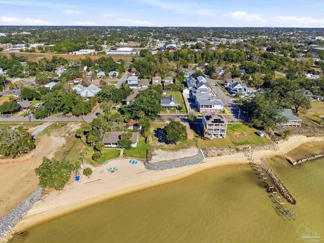 a view of a street with wooden fence
