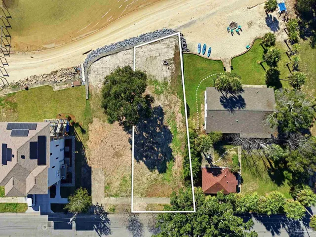 an aerial view of a house with a yard and lake view
