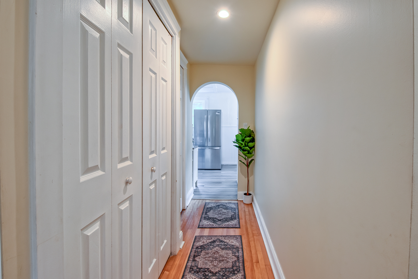207 East Custer Street Lemont, IL 60439 - Photo 15 of 27 a view of a hallway with wooden floor and a bathroom