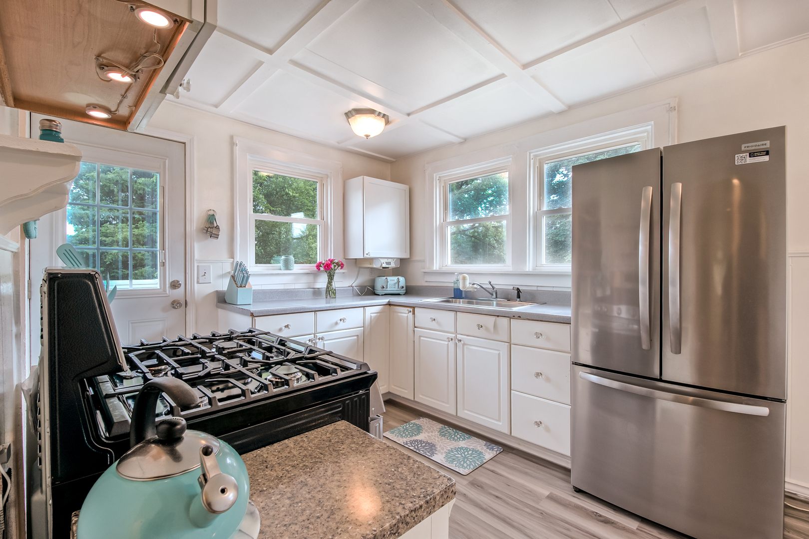 207 East Custer Street Lemont, IL 60439 - Photo 16 of 27 a kitchen with refrigerator a stove a sink dishwasher and white cabinets with wooden floor