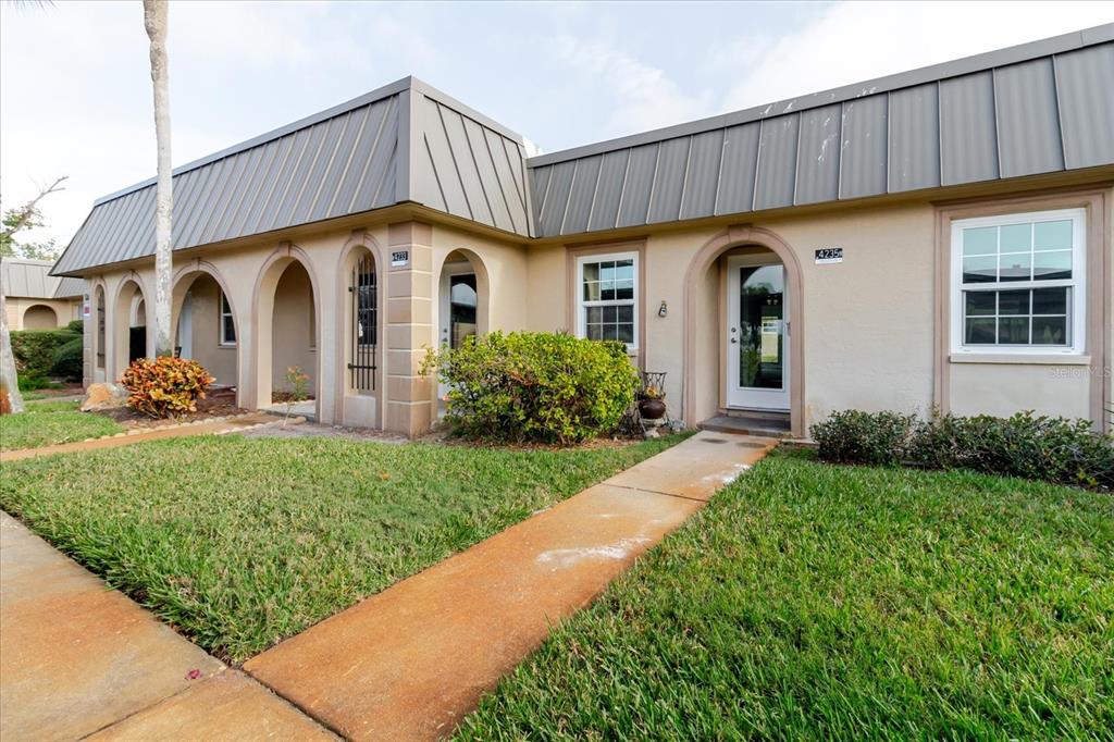 a front view of a house with garden