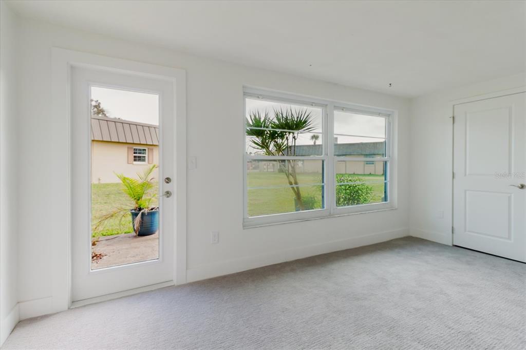 4235 Stratford Drive New Port Richey, FL 34652 - Photo 11 of 32 an empty room with windows and mirror