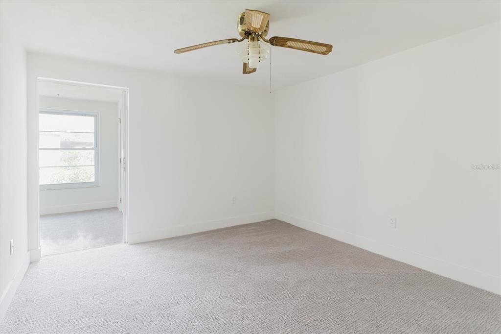4235 Stratford Drive New Port Richey, FL 34652 - Photo 16 of 32 an empty room with windows and fan